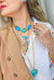 Mix de colares Brisa Tropical com crucifixo e pedras turquesas e coral banhado no dourado