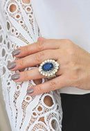 Anel Aconchegar com pedra azul e strass opal banhado no prata