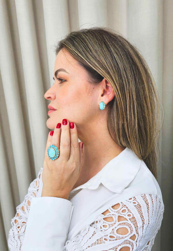 Brinco Oásis oval de pedras azuis banhado no dourado