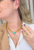 Colar Vasconcelos de elos dourado com pedra azul e pingente de strass pêssego
