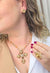 Colar Madeline Gold com pingente de cruz perolas e pedras douradas banhado no dourado